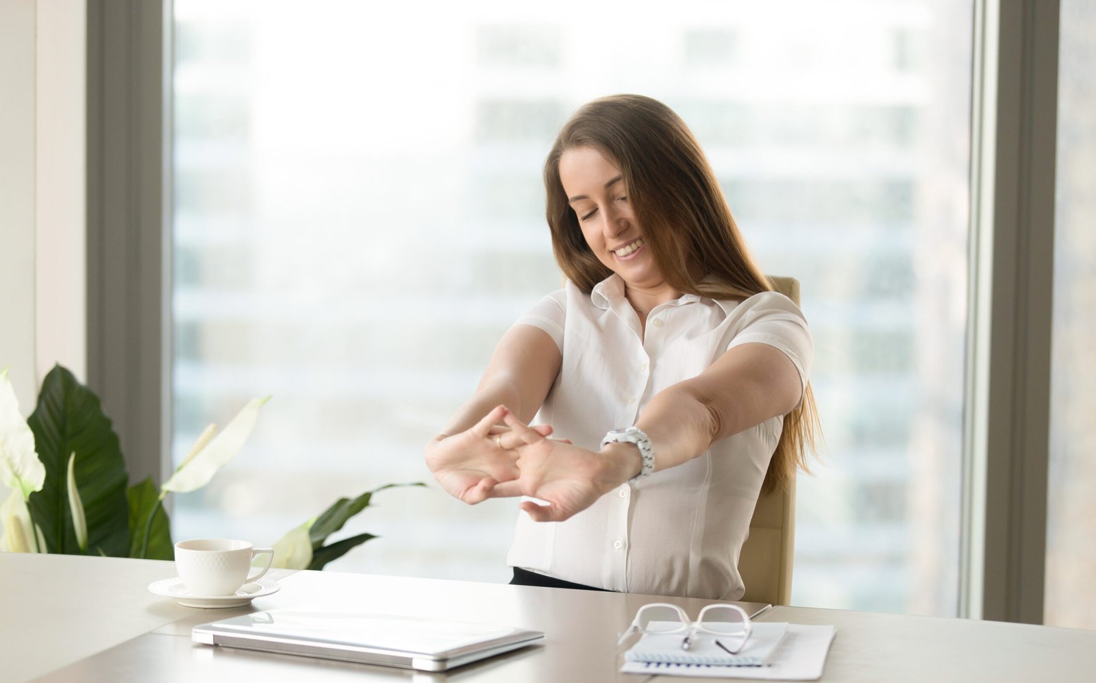 Businesswoman relaxing muscles after finishing job